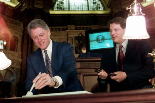 Clinton signs Telcom Act of 1996